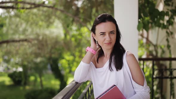 Female Realtor Waiting to Meet a Client Near the House