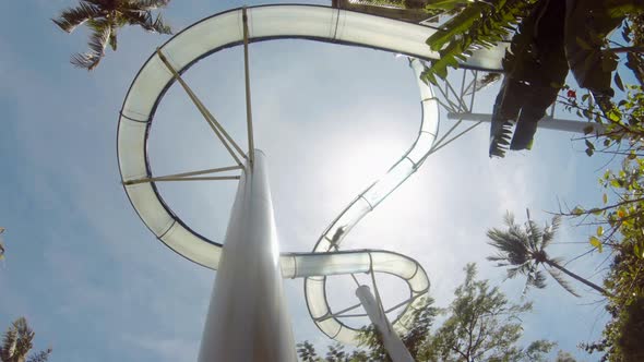 People Sliding Down in a Water Slide. Waterpark Summer Travel Activity Concept. Gopro Footage. Bali
