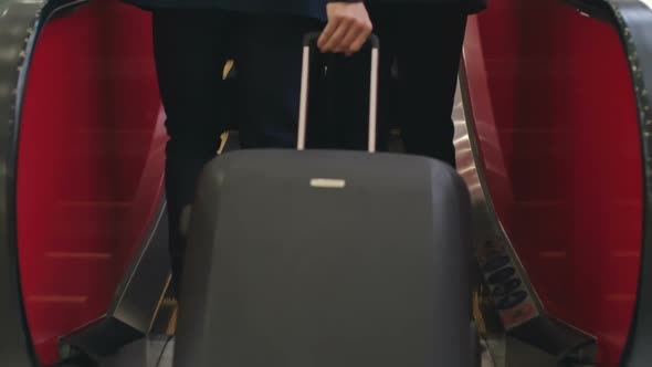 Business Travelers Going Up Escalator