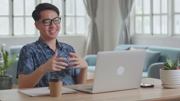 Man With Laptop Computer Having Video Call And Working At Home