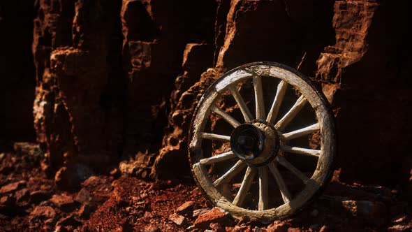Old Wooden Cart Wheel on Stone Rocks