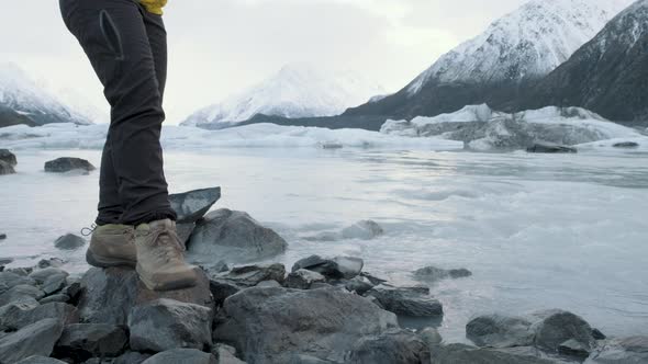 Walking along the edge of a glacial lake in New Zealand in the middle of winter. Surrounded by snow