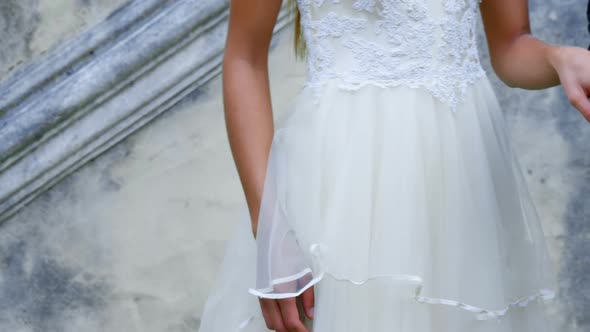 Bride and groom are holding hands by wearing their wedding rings 