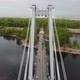 A Man Walks on a Rope Stretched Between the Supports of the Bridge at High Altitude. - VideoHive Item for Sale