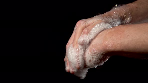 Close up of male hands lathering with soap and foam 