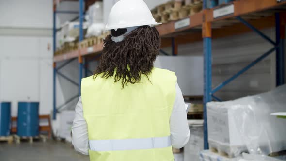 Back View of African American Female Employee in Warehouse