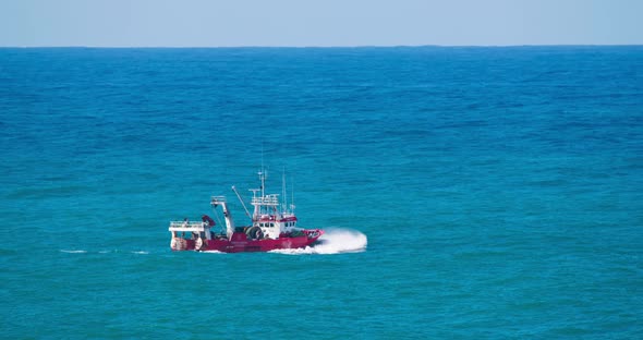 Small Boat Sailing in Open Waters of Atlantic Ocean