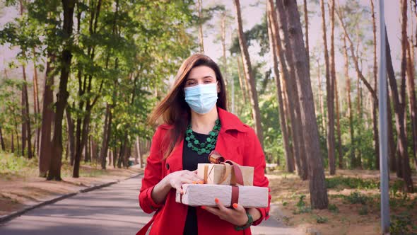 Wrapped Gifts. a Woman in a Protective Mask Holding Several Beautifully Packed Boxes in Her Hands