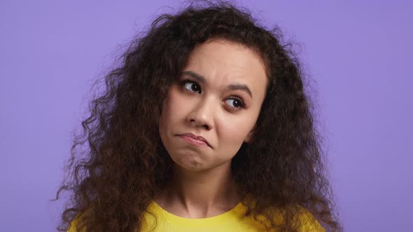 Portrait of Hesitant Girl on Purple Background