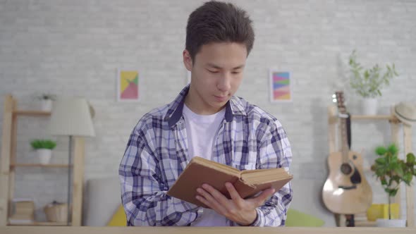 Portrait Young Asian Man Reading Book alt