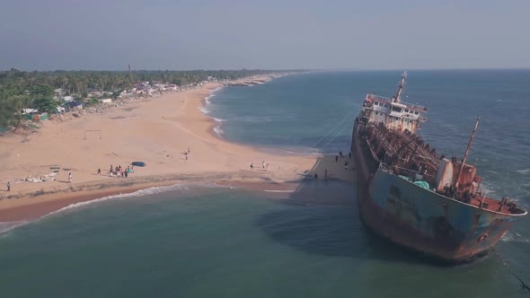 Old shipwreck on a beach near Varkala in Kerala, India. Aerial drone view