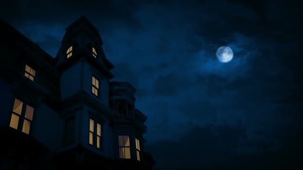 Old Mansion With Lights On And Moon Above