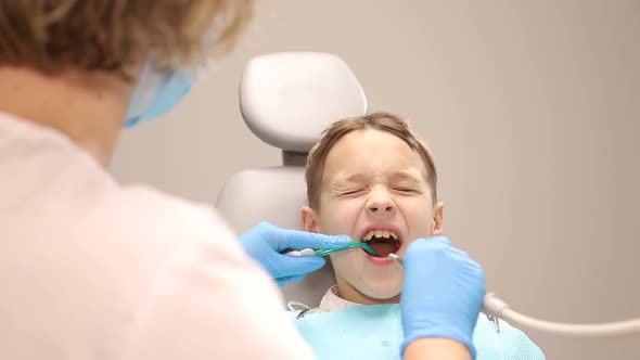 The Child is at the Dentist the Dentist Examines the Baby Teeth