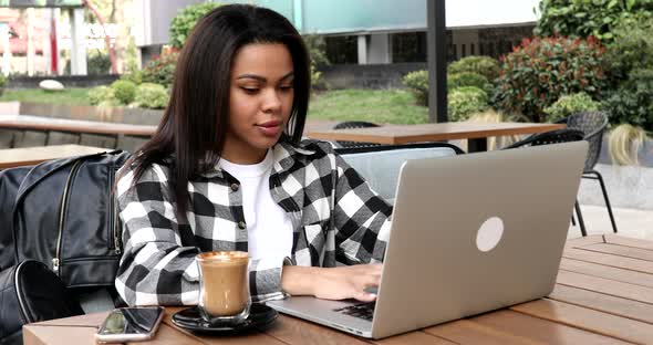 Happy woman completing her work and closing laptop.