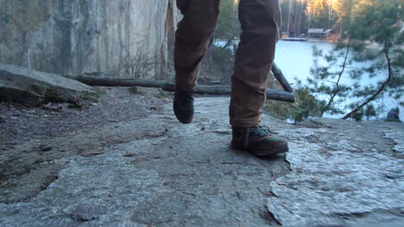 Closeup of Hiking Boots Walks Along the Cliff