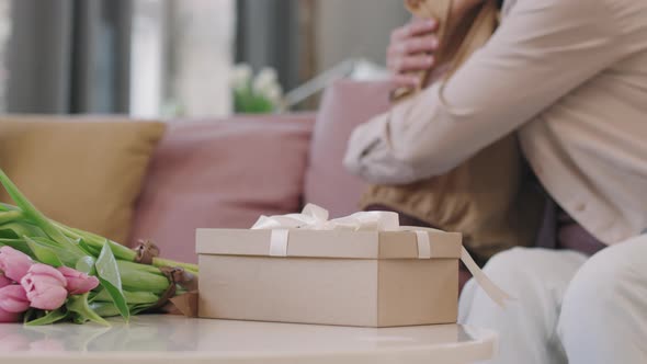 Present Box And Tulips On Table