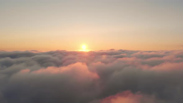 Aerial View of Sunrise Over White Dense Clouds