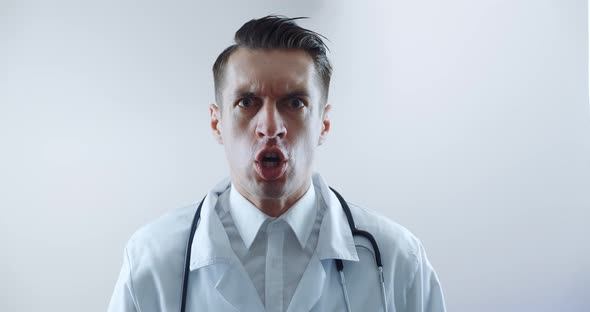 Closeup of Angry Doctor Scolding and Shouting at Employees Threatening with a Finger and Shouting