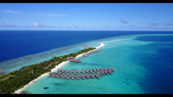 Aerial flying over nature of idyllic lagoon beach wildlife by blue ocean and white sand background o