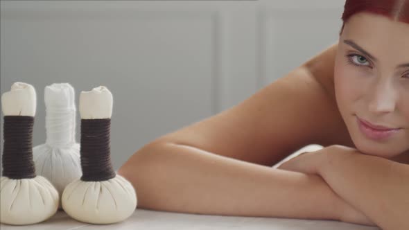 Beautiful woman getting beauty and relaxation treatment procedures in spa salon.