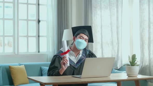 Excited Man Wearing Protection Face Mask And Holding A University Certificate Looking To Camera alt