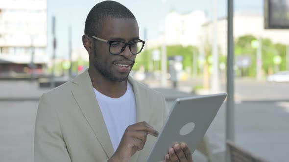 Portrait of African Man Using Digital Tablet Outdoor