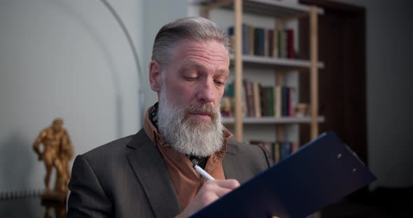 Professional Man Psychologist Consulting Patient at Psychological Appointment in Home Office