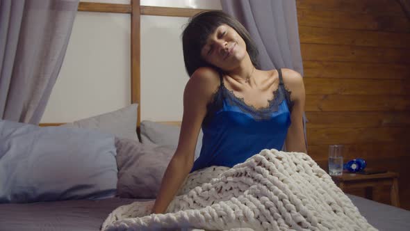 Cheerful Woman Stretching in Bed After Wake Up