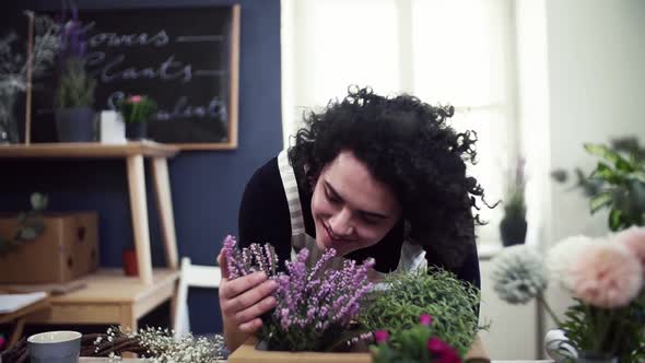 Florist enjoying the smell of blooming flowers