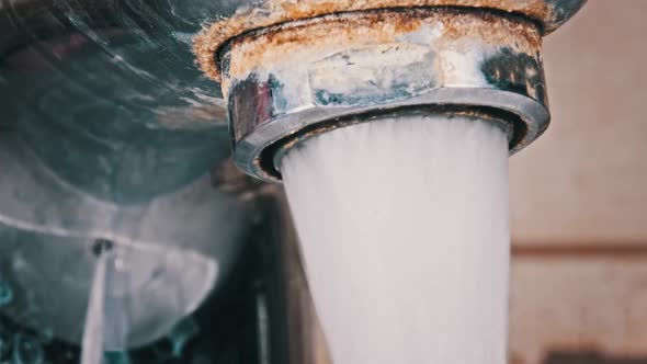 Faucet with Running Water in Slow Motion Macro Shot