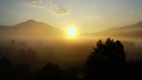 Drone Over Ethereal Misty Landscape Of Zell Am See Towards Sunrise