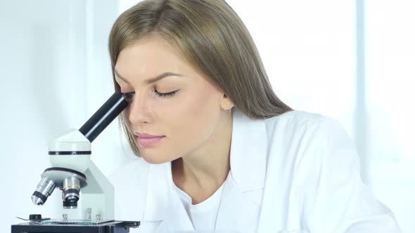 Female Scientist Doctor Working on Microscope in Laboratory