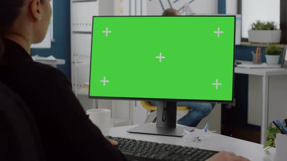 Close Up of Computer with Horizontal Green Screen on Desk