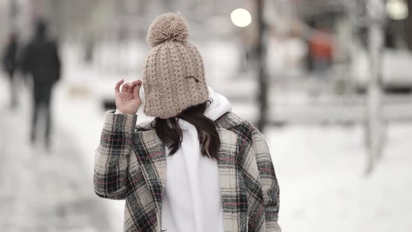 Fooling Around Woman Is Wearing Glasses Over Knitted Hat on Face at Winter Day Walking in City Fun