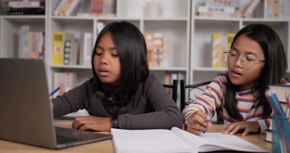 Two girls learning online at home