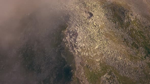 Aerial drone slowly panning up facing a mountain peak.