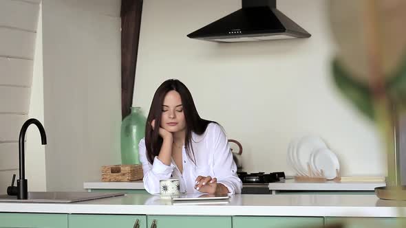 Girl using tablet in the kitchen