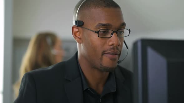 Businessman talking with headset in office