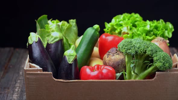 A Box Full of Fresh Vegetables on a Dark Background Wooden Vintage Table