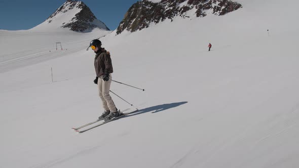 Young Woman Skiing Down Mountain Side