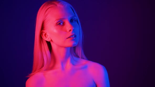 Portrait of a Young Attractive Woman in Colored Lighting