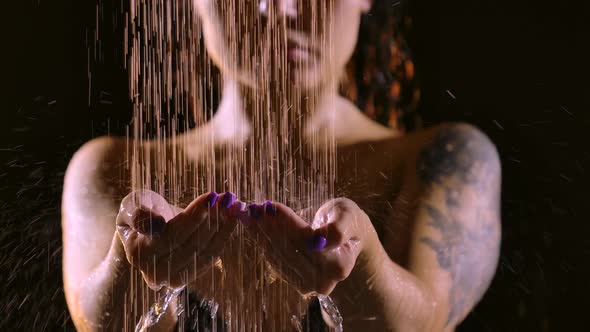 Attractive Woman Takes a Shower in Slow Motion on a Black Studio Background. Close Up Beautiful