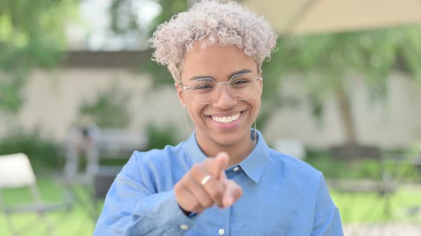 Portrait of Young African Woman Pointing Towards Camera