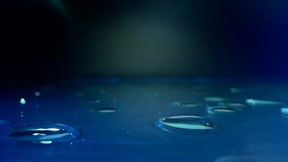 Water Concept. on the Glass Surface with Blue Loght and Many Drops on the table.Water Is a