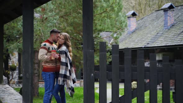 Young couple in love outdoors. Date of happy couple at front yard in autumn