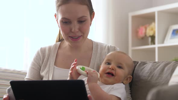 Mother with Baby Having Video Call on Tablet Pc