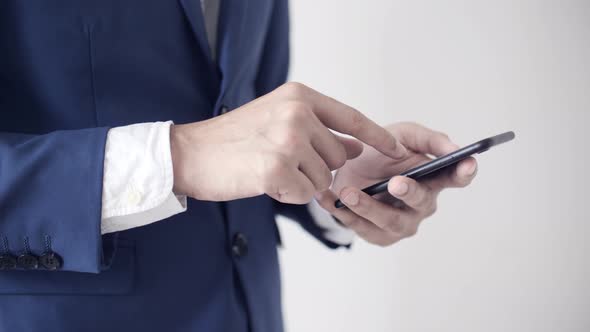 Businessman Playing Smartphone