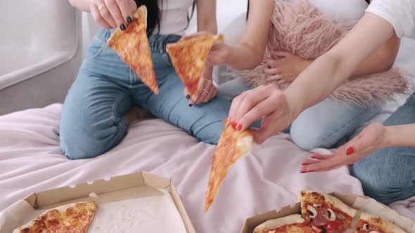 Close-up of Cut Takeaway Pizza Shared By Girls in the Bed