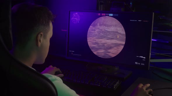 Internet Battle Player Focused On Winning In-game Challenge At Cyber Sport Club alt