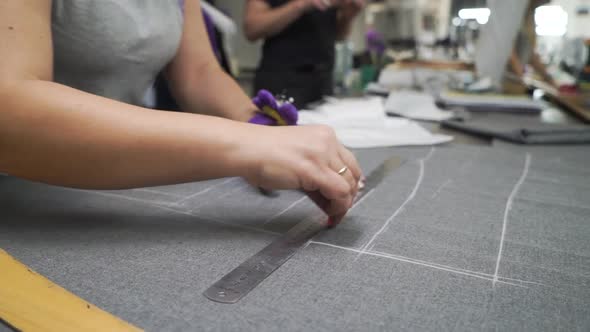 Worker Sewing Production Makes a Mark on the Details of the Cut